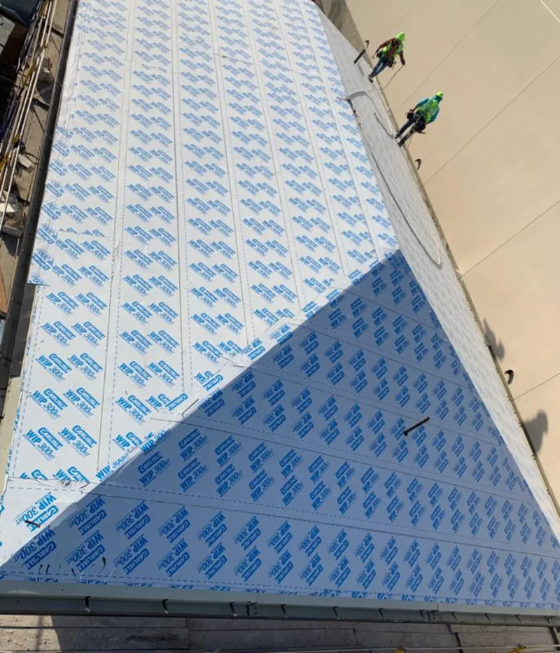 Professional roofers installing underlayment on a metal roof in Accokeek